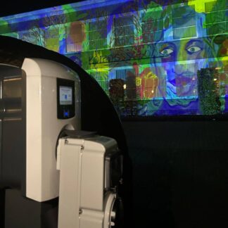 Videomapping on building with the chargepoint and adapter on the foreground.