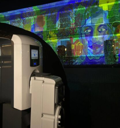 Videomapping on building with the chargepoint and adapter on the foreground.
